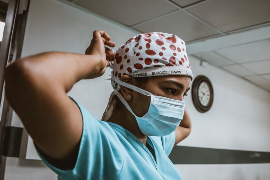 A variety of medical scrubs in different sizes and colors displayed on hangers, showcasing the importance of proper fit and measurement.