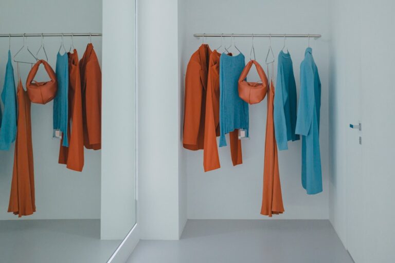 A collection of colorful scrubs neatly arranged on hangers, showcasing various styles and fabrics suitable for healthcare professionals.