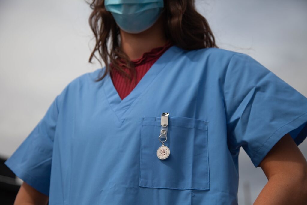 A healthcare professional wearing comfortable medical scrubs in a busy hospital environment, showcasing the functionality and style of scrubs during a long shift.