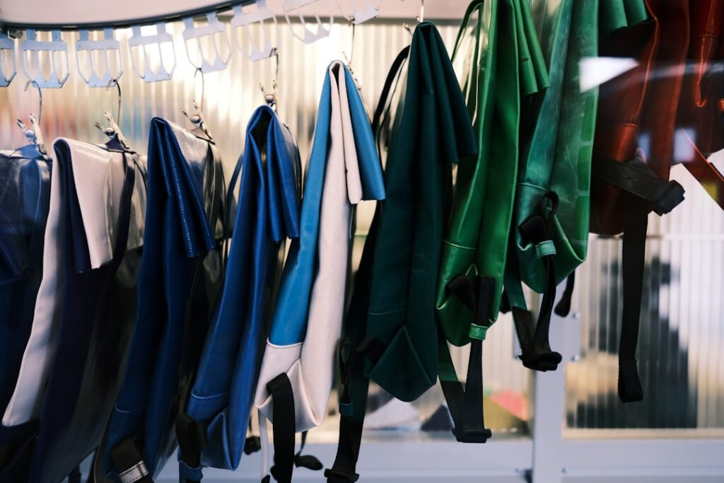A variety of colorful scrubs hanging on a rack in a healthcare setting, showcasing different colors and styles suitable for various medical environments.