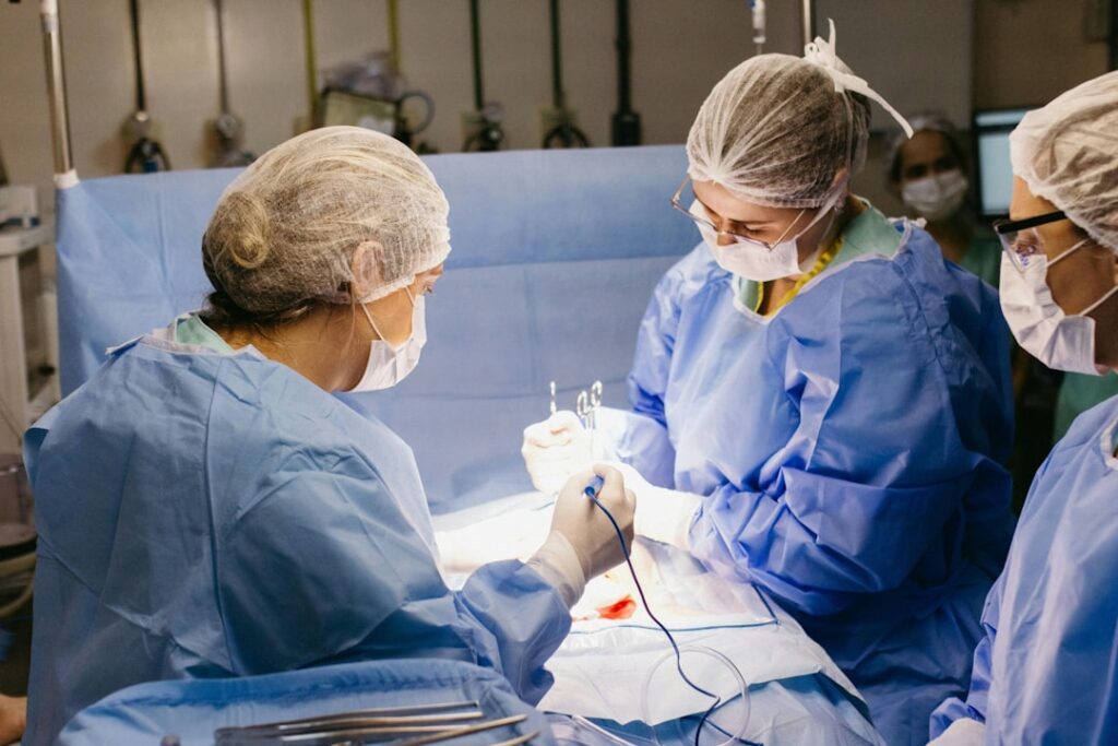 A diverse group of healthcare professionals wearing colorful scrubs in a clinical setting, showcasing teamwork and professionalism.